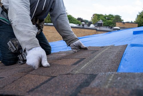 technician repairing a roof